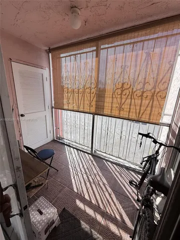 a view of a balcony with furniture