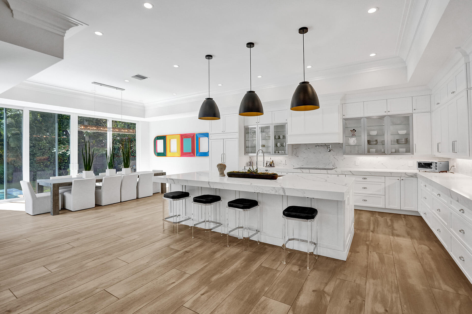 700 Northwest 6th Street Boca Raton, FL 33486 - Photo 13 of 40 a kitchen with stainless steel appliances granite countertop a stove a sink and a white cabinets with wooden floor