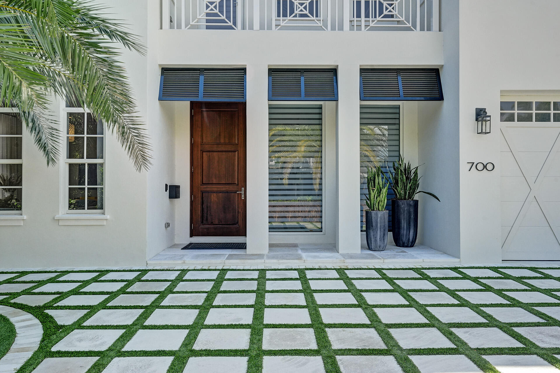 700 Northwest 6th Street Boca Raton, FL 33486 - Photo 2 of 40 a couple of flower plants in front of a house
