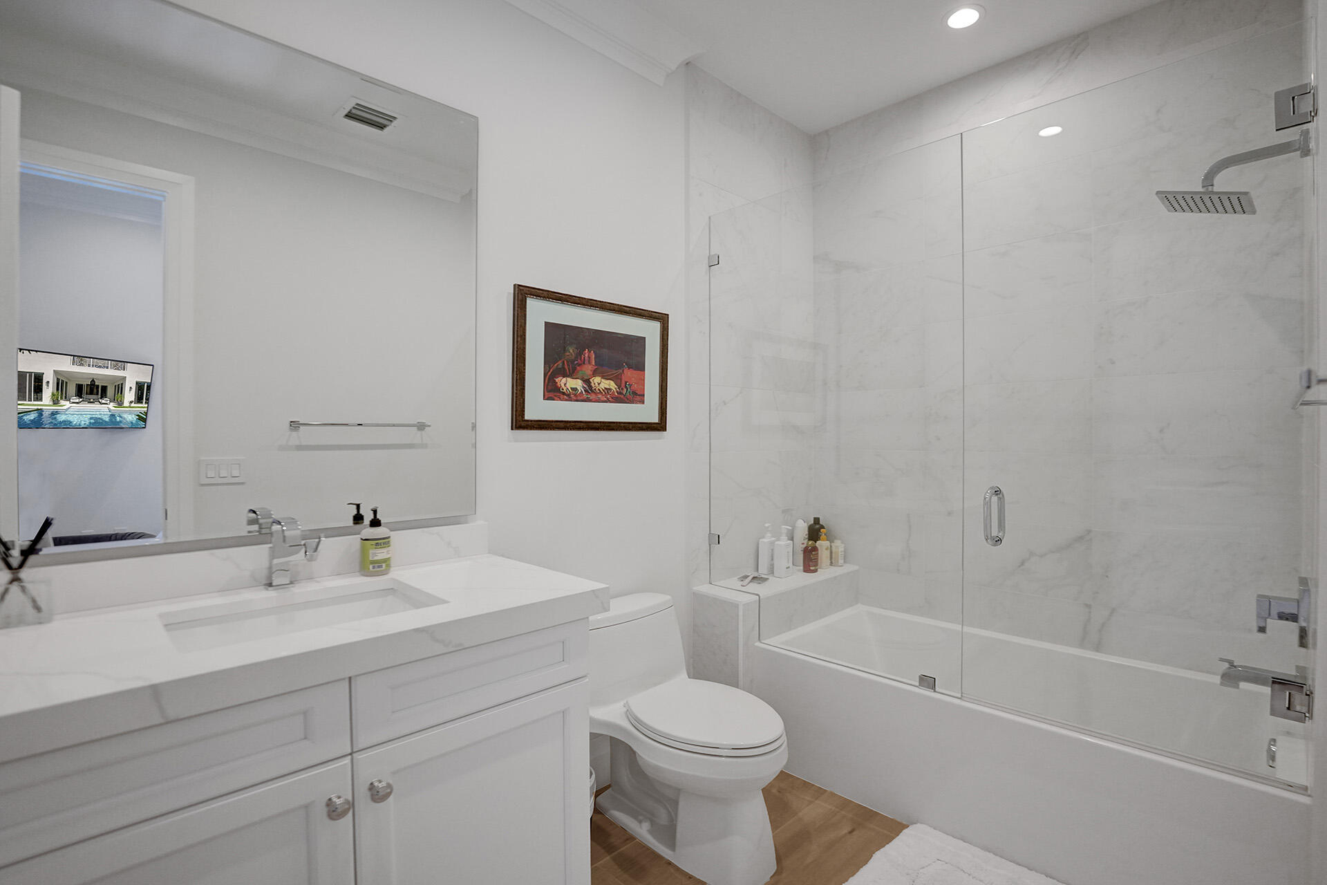 700 Northwest 6th Street Boca Raton, FL 33486 - Photo 26 of 40 a bathroom with a toilet a sink a mirror a bathtub and vanity