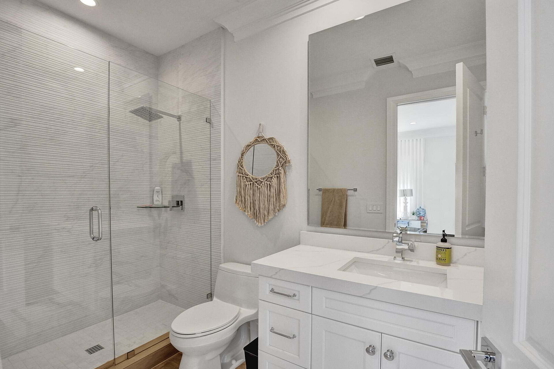 700 Northwest 6th Street Boca Raton, FL 33486 - Photo 29 of 40 a bathroom with a toilet a sink a mirror and shower