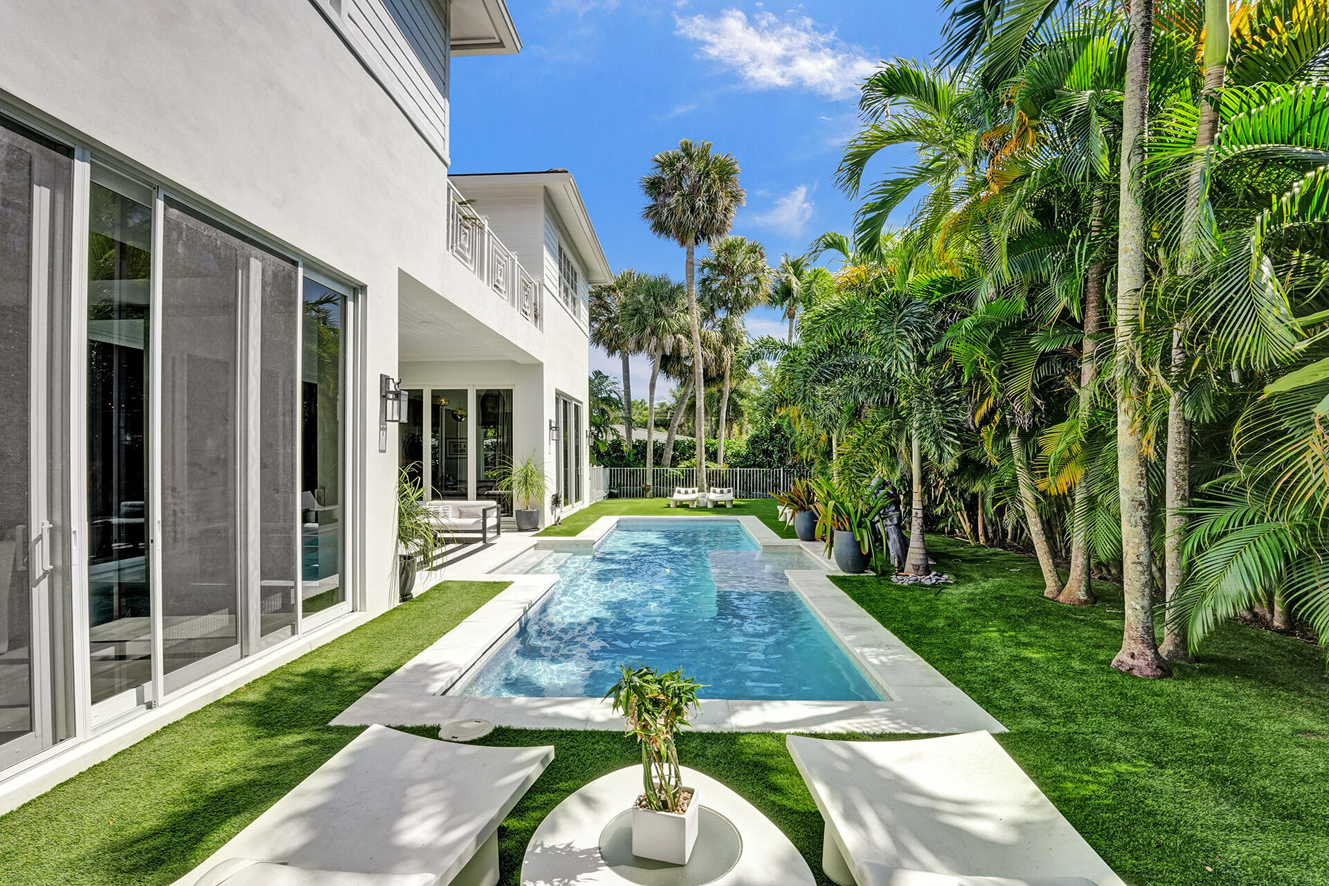 700 Northwest 6th Street Boca Raton, FL 33486 - Photo 37 of 40 a view of a backyard with table and chairs potted plants and floor to ceiling window