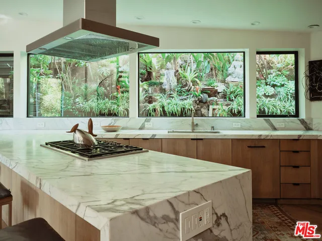a kitchen with a sink and a large window