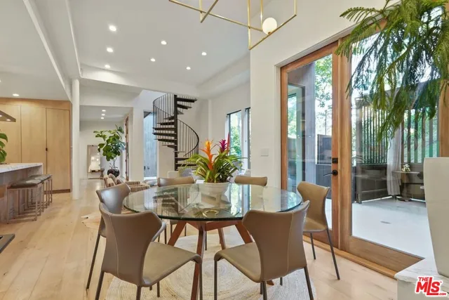 a dining room with furniture and wooden floor