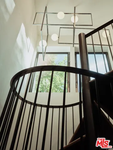 a view of staircase with lots of frames on wall