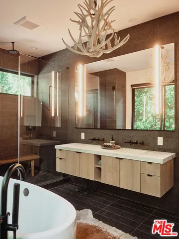 a large bathroom with a large tub and sink