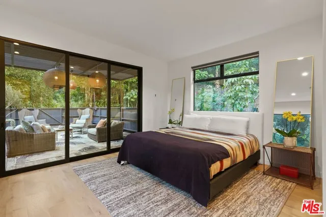 a bedroom with a bed and large window