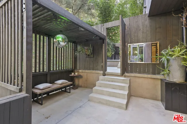 a view of a table and chairs in backyard of the house
