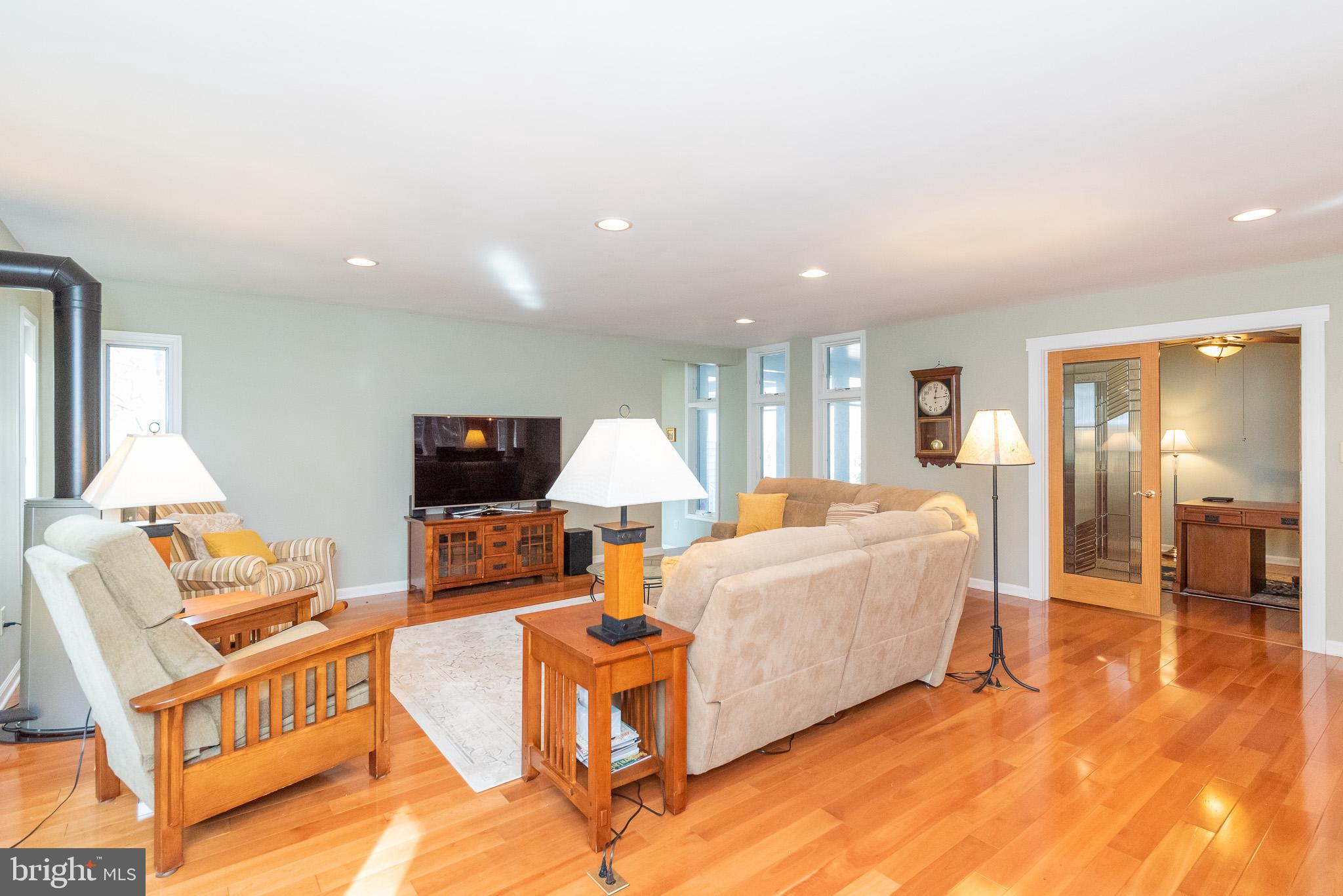 16550 Yeoho Road Sparks, MD 21152 - Photo 11 of 67 a living room with furniture a lamp and a flat screen tv