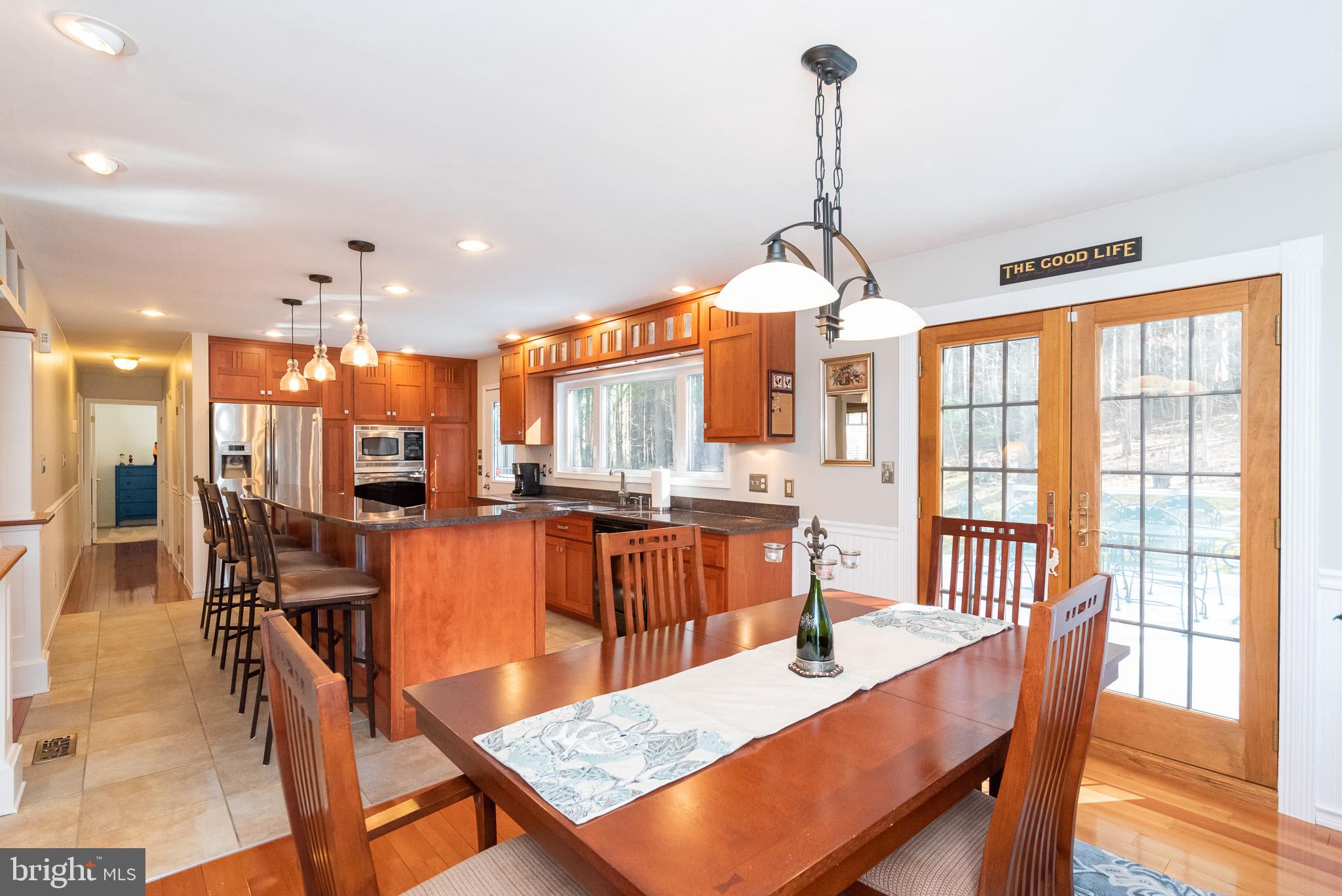 16550 Yeoho Road Sparks, MD 21152 - Photo 14 of 67 a dining room with furniture a chandelier and wooden floor