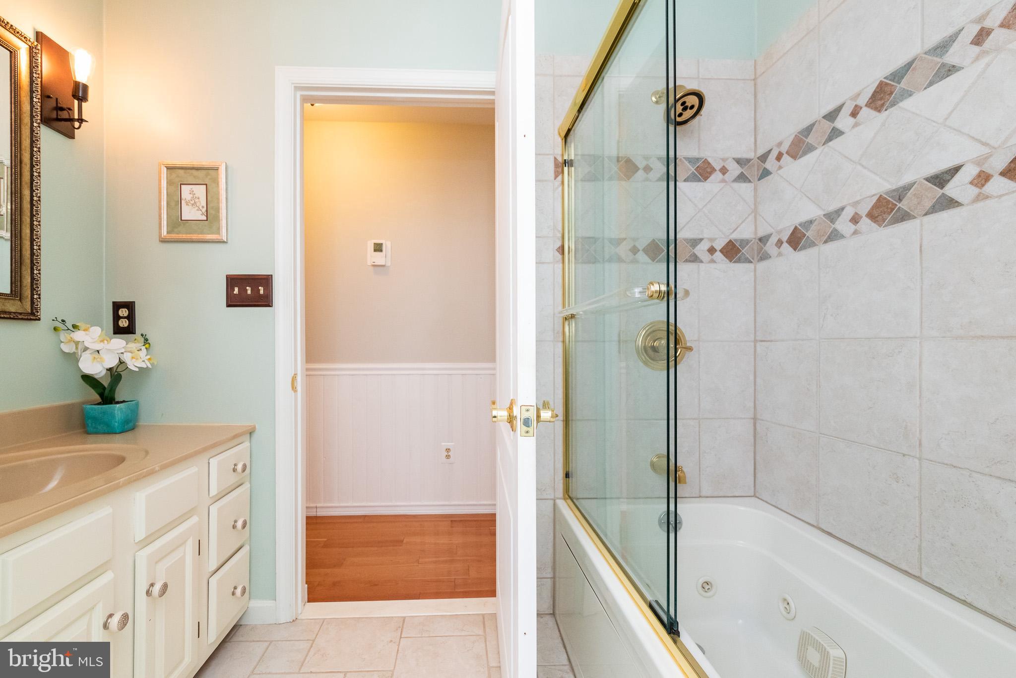 16550 Yeoho Road Sparks, MD 21152 - Photo 26 of 67 a bathroom with a tub shower sink and mirror