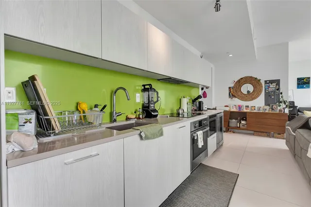 a kitchen with stainless steel appliances granite countertop a sink and stove