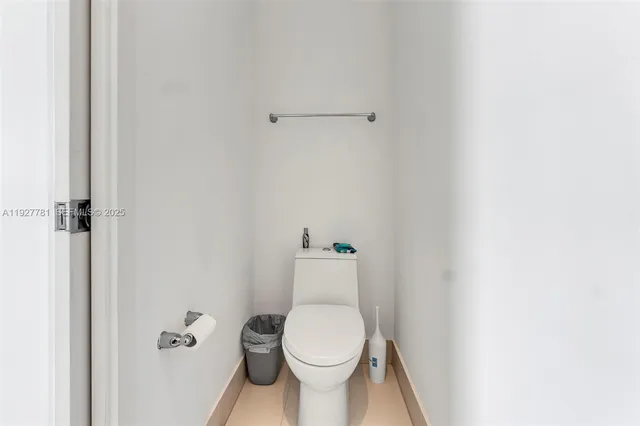 a white toilet sitting next to a white cabinet