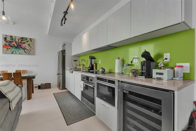 a kitchen with stainless steel appliances kitchen island granite countertop a sink and cabinets