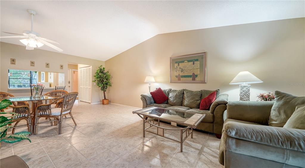 5649 Summerside Lane, Unit 41B Sarasota, FL 34231 - Photo 12 of 41 a living room with furniture a chandelier and a dining table