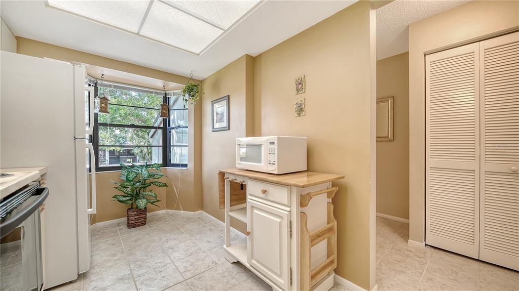 5649 Summerside Lane, Unit 41B Sarasota, FL 34231 - Photo 14 of 41 a view of a kitchen with fridge and front door