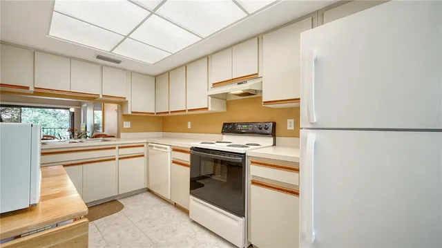 a kitchen with cabinets and stainless steel appliances