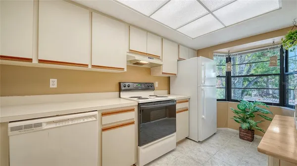 a kitchen with appliances cabinets and a sink
