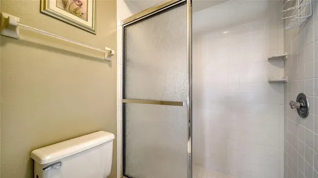 a bathroom with a toilet and a shower