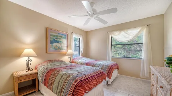 a bedroom with two beds and a chandelier