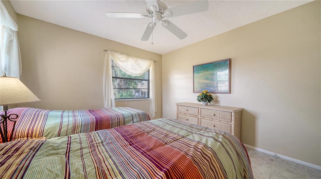 5649 Summerside Lane, Unit 41B Sarasota, FL 34231 - Photo 28 of 41 a bedroom with a large bed and a window