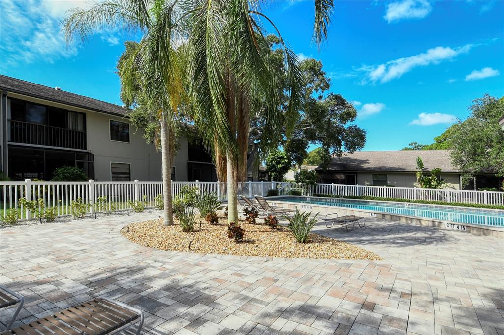 5649 Summerside Lane, Unit 41B Sarasota, FL 34231 - Photo 37 of 41 a view of backyard with wooden fence and large trees