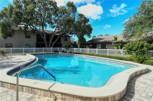 a view of a swimming pool with chairs
