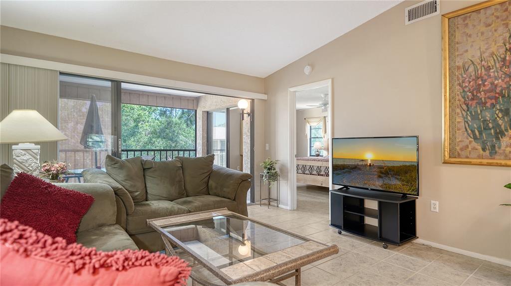 5649 Summerside Lane, Unit 41B Sarasota, FL 34231 - Photo 7 of 41 a living room with furniture and a flat screen tv