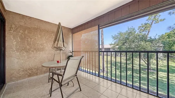 a view of a chair and table in the balcony