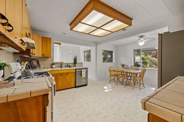 a view of a kitchen with dining table and chairs