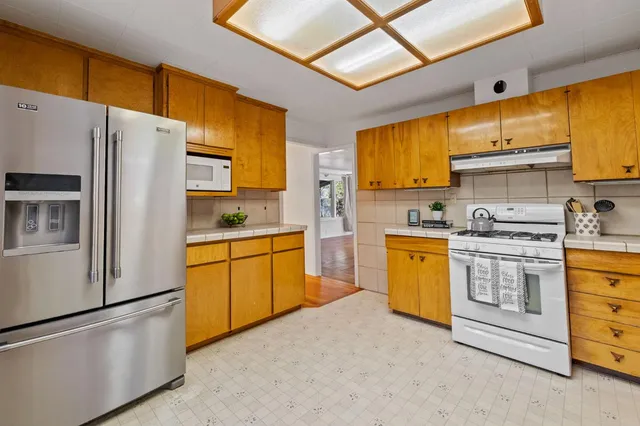 a kitchen with appliances a sink and counter