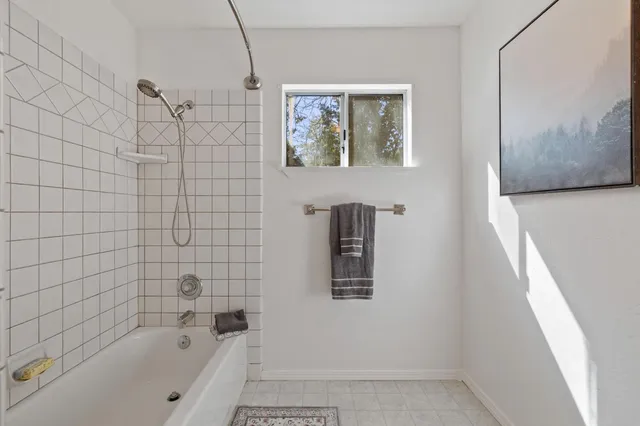 a bathroom with a bathtub and shower