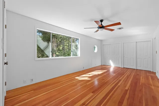 a view of room with window and ceiling fan