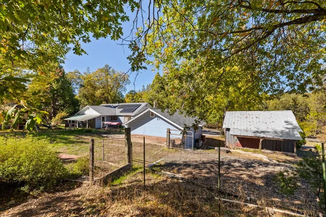 a backyard of a house with table and chairs