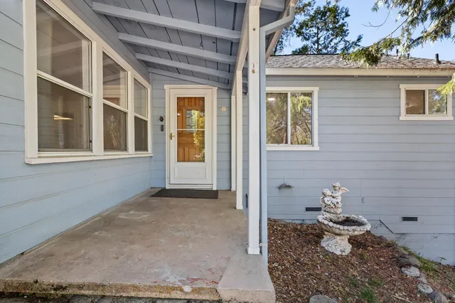 a front view of a house with outdoor seating