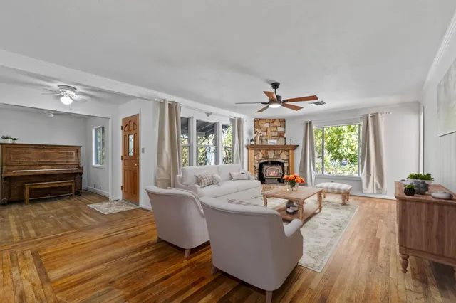 a living room with furniture a fireplace and a large window