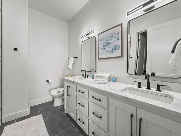 a bathroom with a toilet sink and mirror