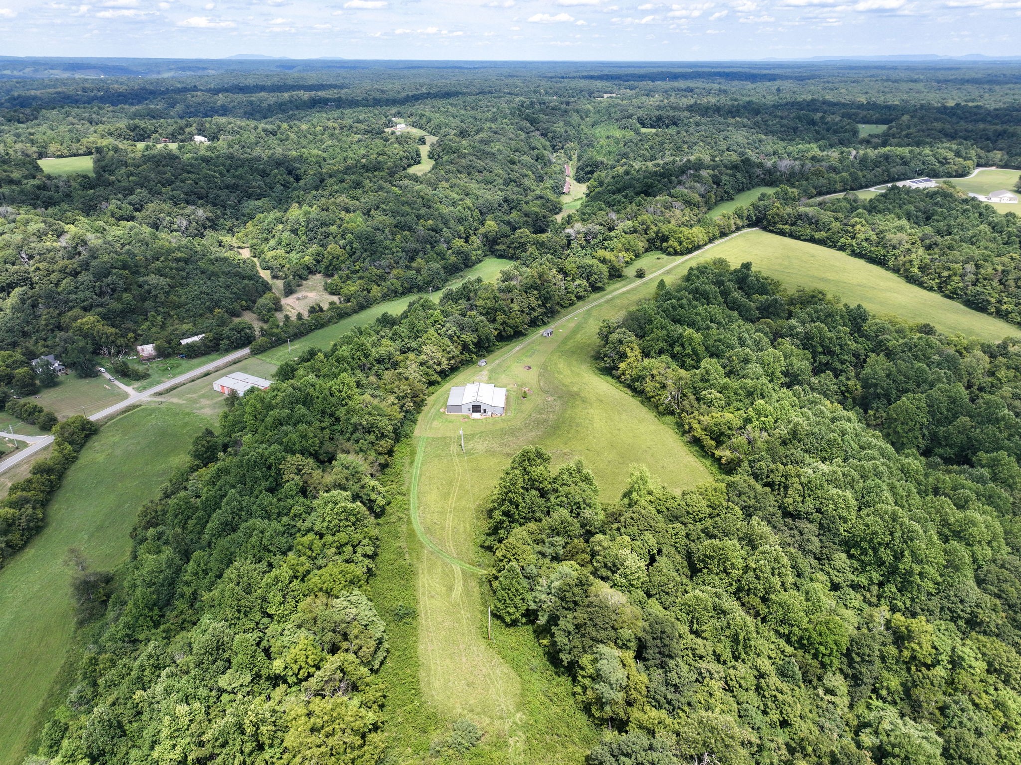 631 Union Ridge Road Wartrace, TN 37183 - Photo 23 of 26 a view of a lush green forest with trees and some houses