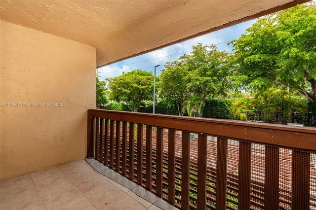 a view of a bathroom with white cabinets and a sink