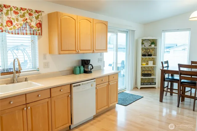 a kitchen with a sink a stove and cabinets
