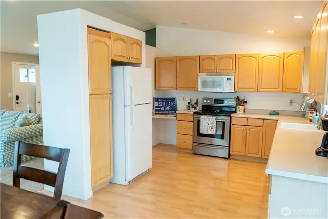a kitchen with a table chairs sink and cabinets
