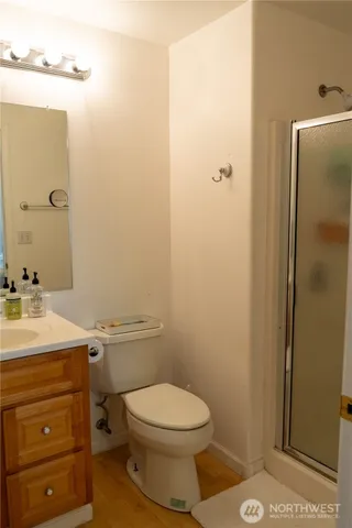 a bedroom with a bed and a night stand