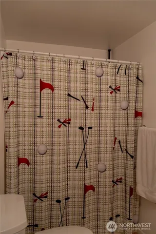 a utility room with water heater and racks