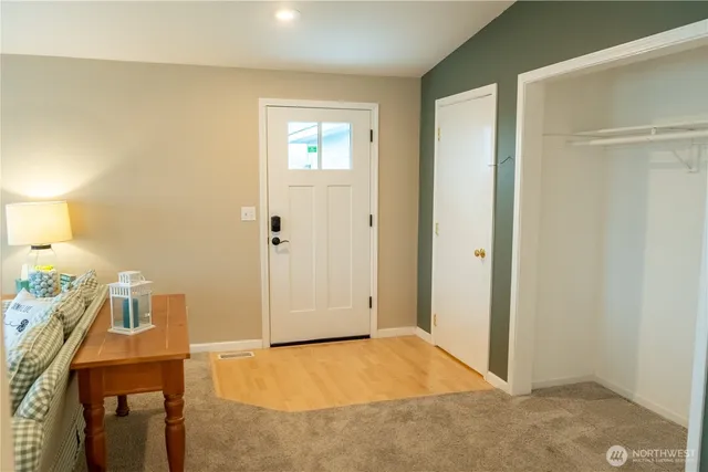 a living room with furniture a flat screen tv and a floor to ceiling window