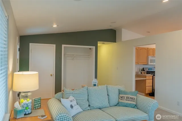 a kitchen with stainless steel appliances granite countertop a sink a stove cabinets and a window