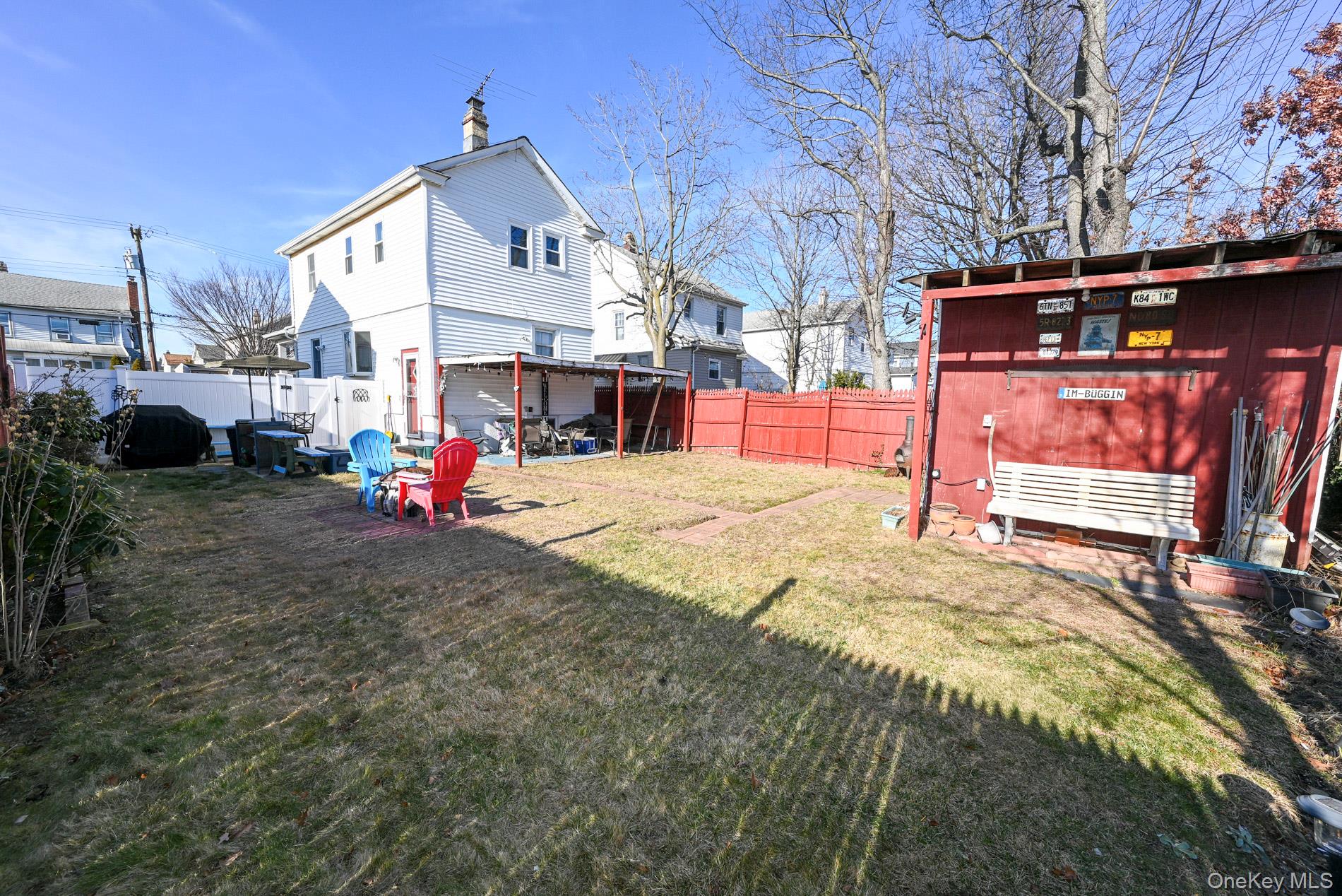 165 Cochran Place Valley Stream, NY 11581 - Photo 20 of 25 Rear view of property featuring a fenced backyard and a chimney
