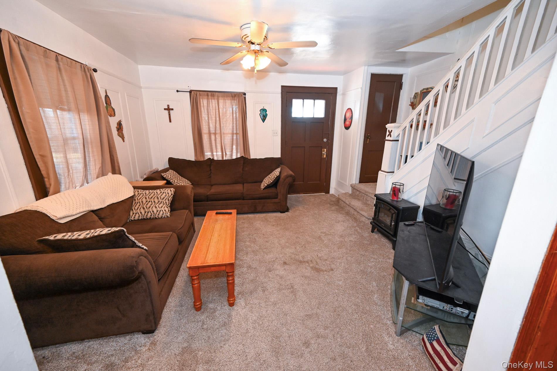 165 Cochran Place Valley Stream, NY 11581 - Photo 4 of 25 Carpeted living area with stairs and a ceiling fan