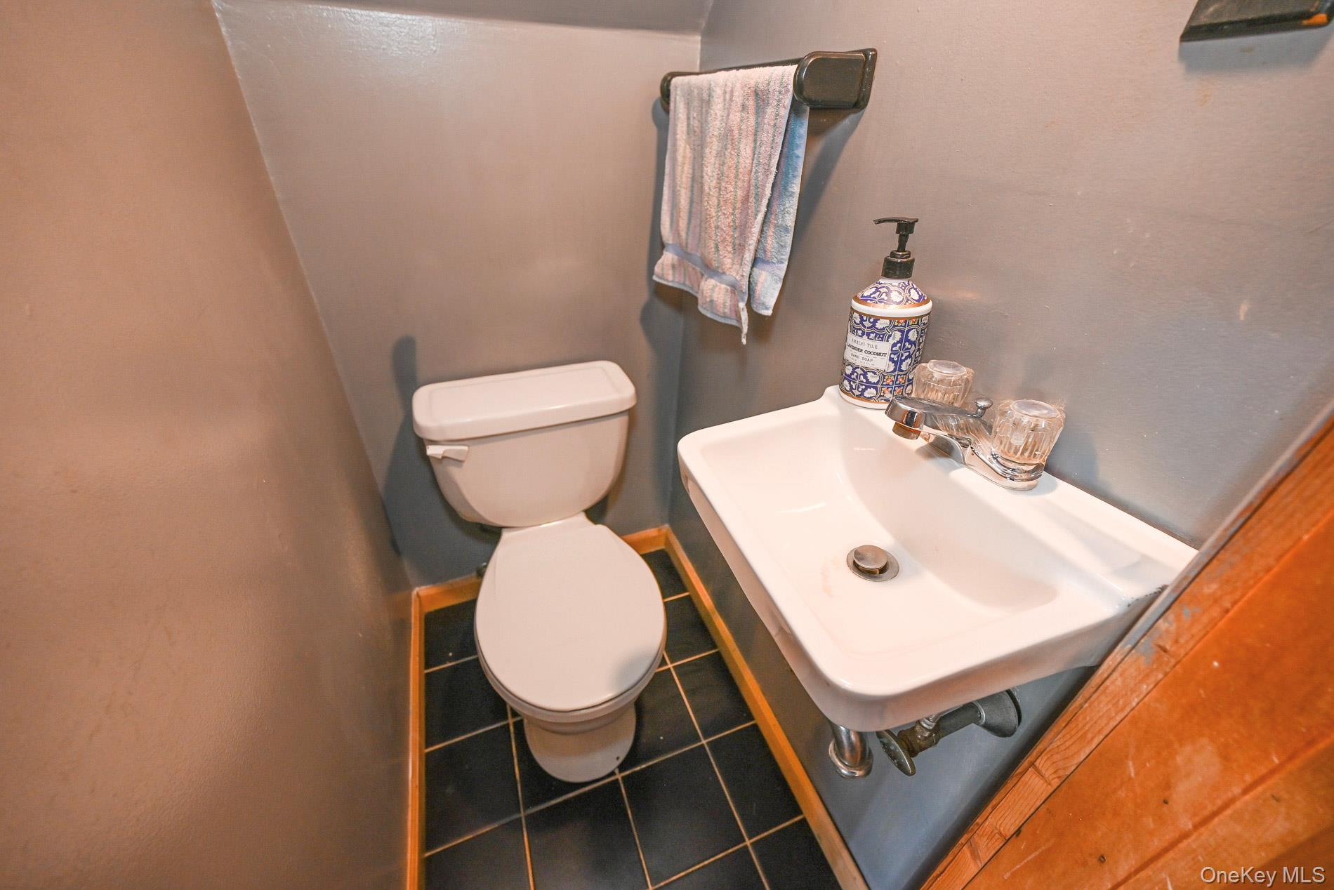165 Cochran Place Valley Stream, NY 11581 - Photo 9 of 25 Half bathroom with toilet and tile patterned flooring