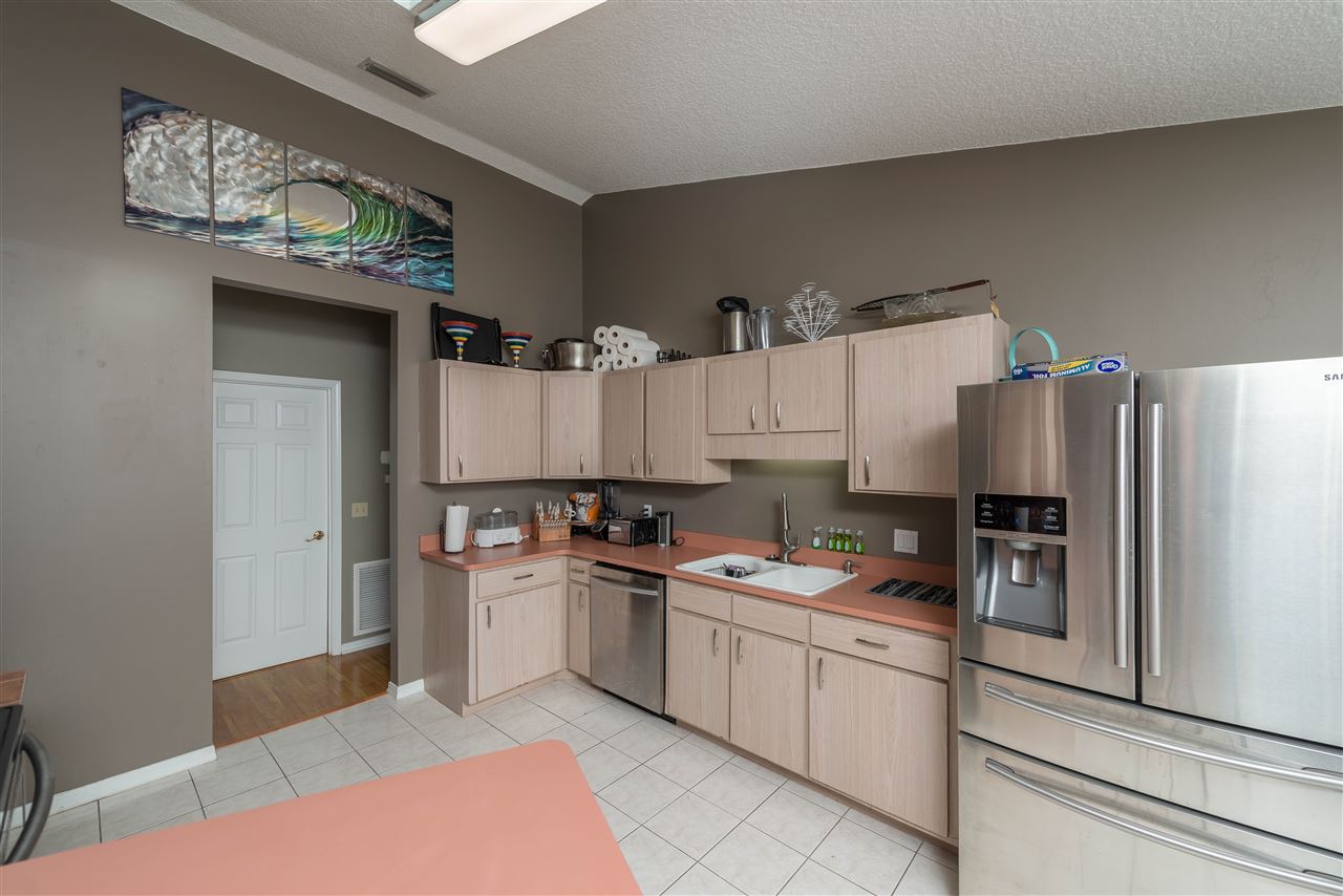 541 Moultrie Wells Road St. Augustine, FL 32086 - Photo 23 of 25 a kitchen with a sink a refrigerator and cabinets