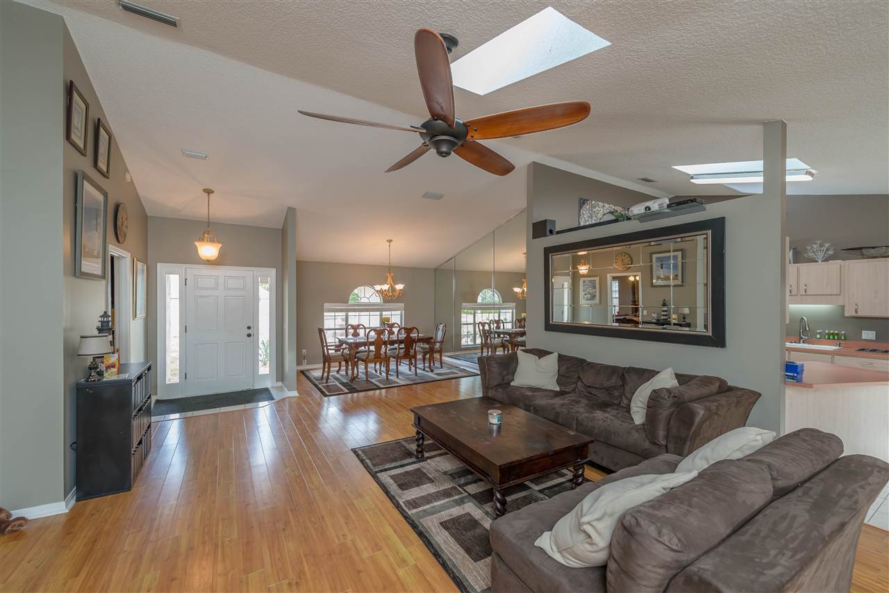 541 Moultrie Wells Road St. Augustine, FL 32086 - Photo 5 of 25 a living room with furniture and a wooden floor